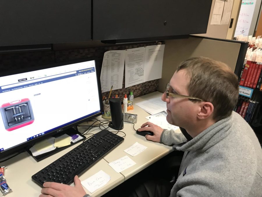 Young adult librarian Michael Cherry works at his desk at the Young Adult Center. The Young Adult Center will be hosting events throughout the year such as Finding your College Fit.