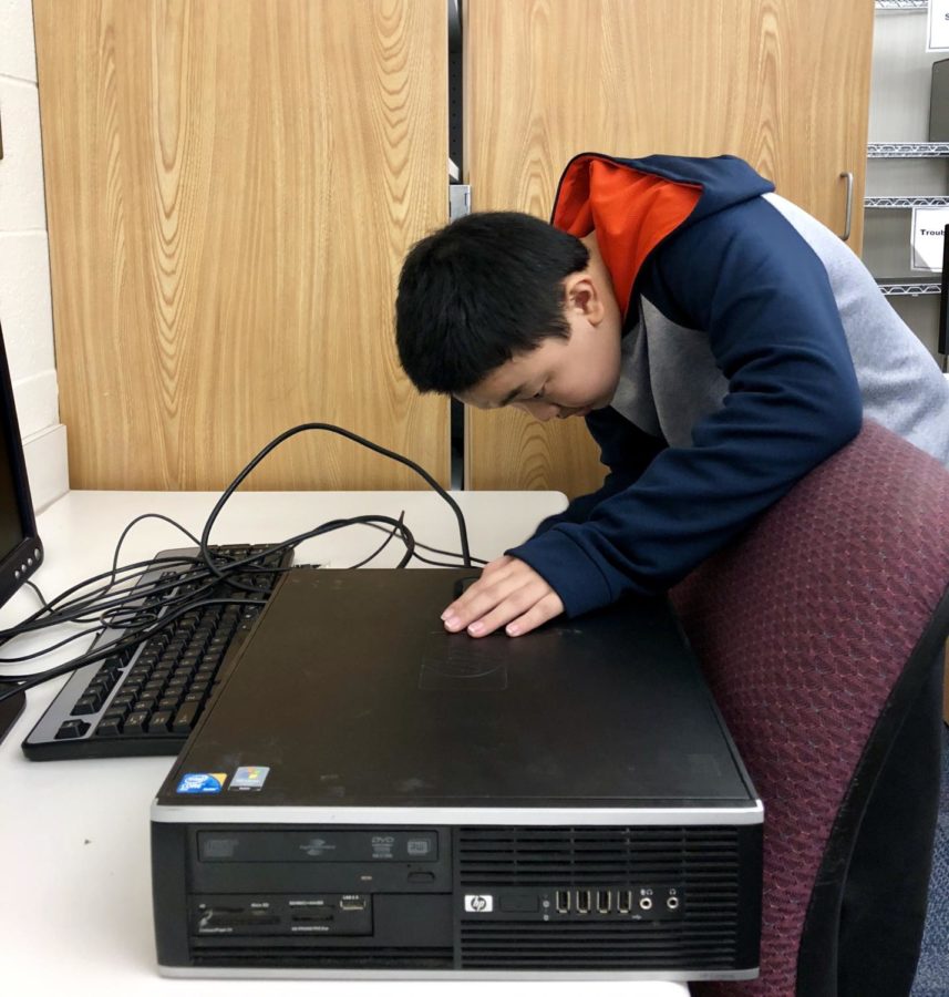 Evan Shi, club member and freshman, starts off the weekly meeting by checking the software of a computer donated by Net-Literacy. This is Shi’s first year as a Computer Club member.