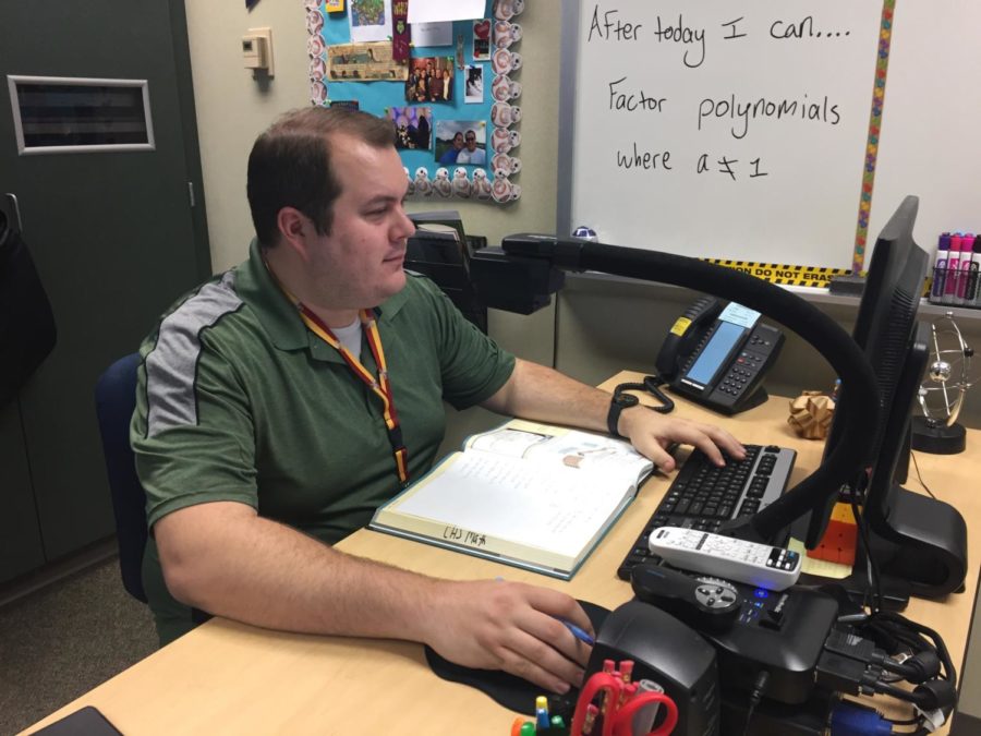 Sponsor and math teacher, Joseph Broman, prepares to print out copies of practice tests for the upcoming AMC competition. Broman said the practice tests will prepare the members for the different style of the test.