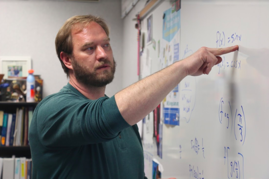 TEACHING TIME:
Math teacher Peter Beck teaches his multivariable malculus class at the end of the day. He explained a problem to a student at the end of class to help them better understand the concept. 