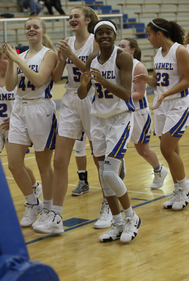 Greyhounds forward and senior Reagan Hune celebrates with her team after a win. Hune is averaging 11.5 points per game. 