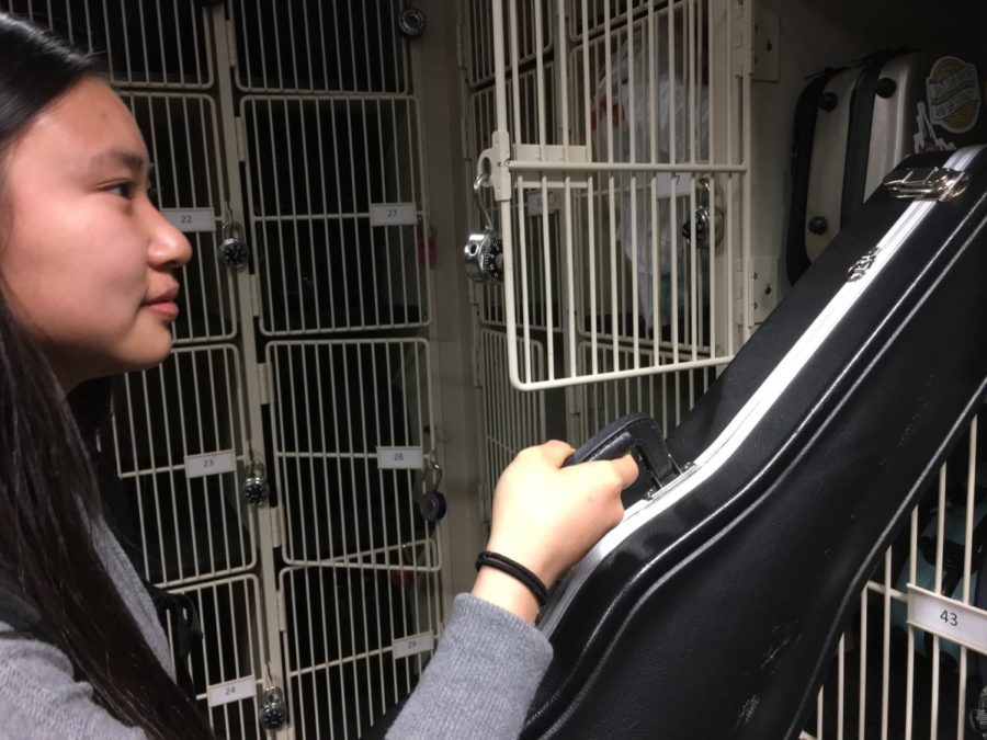Alia Rumreich, member of Philharmonic Orchestra and sophomore, takes her violin out of its locker to practice at home. She said she and her orchestra have been focusing on preparing for the ISSMA competition, which is in April.