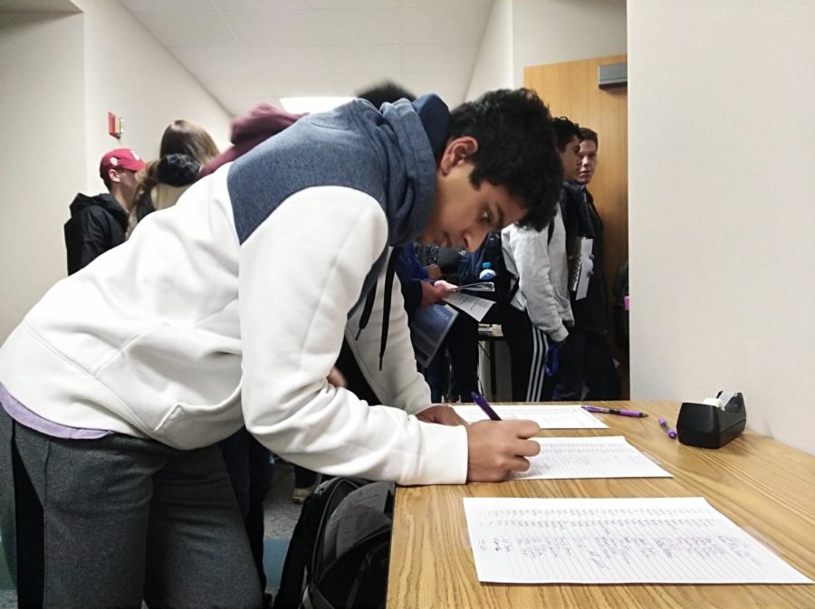  Junior Mohnish Pandey signs into a mandatory ICDC meeting before school on Mar. 12. Mohnish along with other members qualified for ICDC by placing at the top of their event at the state competition. 