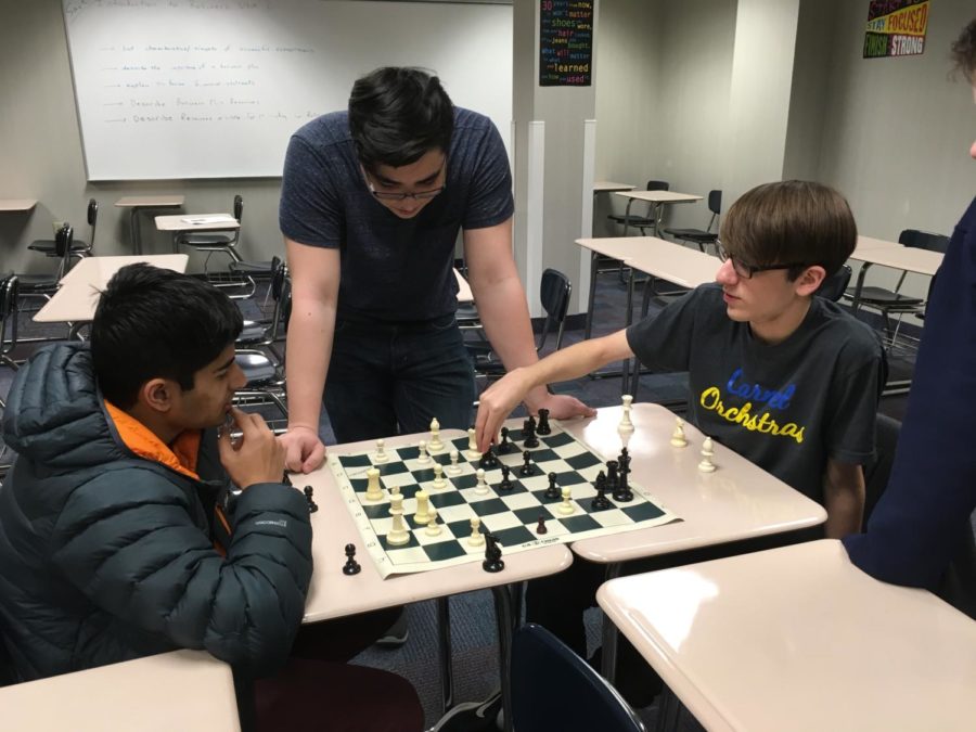 Julian Knudson, president of the club and senior, oversees a game between Rohil Senapati and Owen Eckart. Knudson said he has finalized the A, B, and C teams for the tournament, which he compiles based on skill demonstrated by students throughout the year.