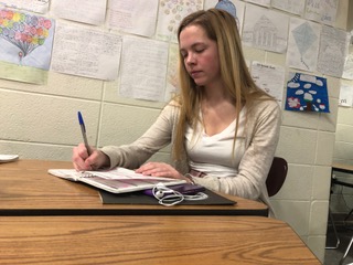 Anne Schuh, Best Buddies president and senior, fills in her planner during SRT. Schuh said the Best Buddies club filmed a music video that celebrates friendship during SRT that will be played sometime in March, which is Developmental Disability Awareness Month.