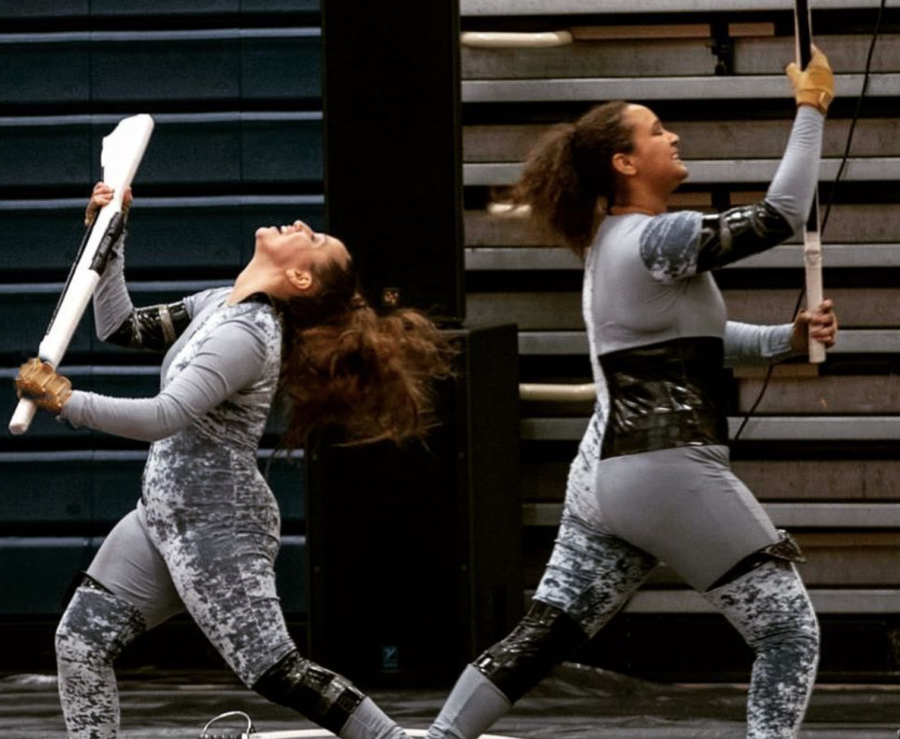 Two guard members successfully catch their rifles during a practice in the gym on March 13. As the winter guard season draws to a close, guard director Rosie Queen said the guard is shaping up to finish strong in the final stretch of competitions.