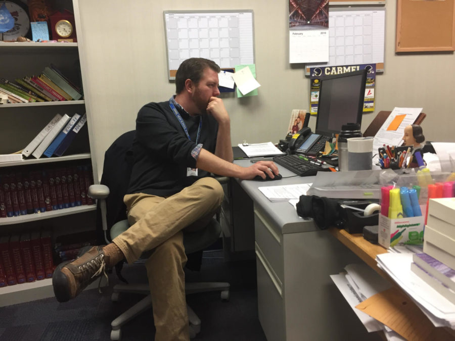 Chad Andrews, Teens with a Choice sponsor, works at his desk after school. He said the club has slowed down this semester.
