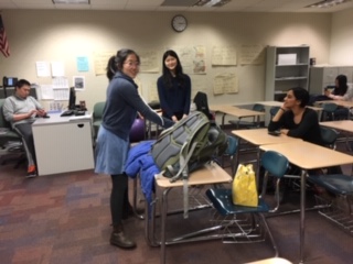 Selin Oh, TEDx president and senior, unpacks her bag before a TEDx meeting. She said her current focus is to work with the new leadership team, so they will be ready to take over next school year.