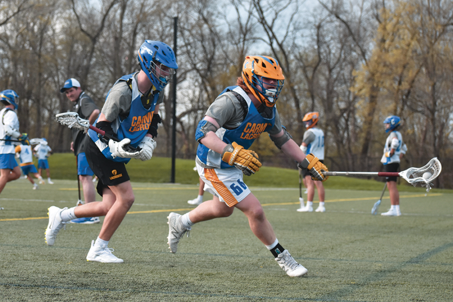 PLAY BY PLAY:
Senior Joe Pendl and sophomore Daniel Seed, varsity lacrosse players, race for the ball during a speed drill. Meachum explained that strategy and speed were important for success.