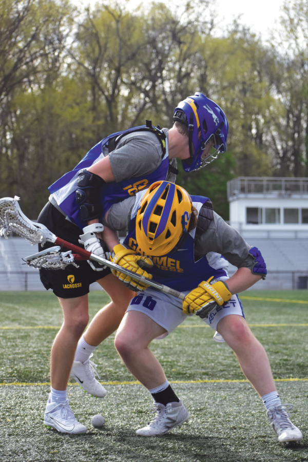 SPLIT- SECOND REACTION:
Joe Pendl, varsity lacrosse player and senior, and Daniel Seed, varsity player and sophomore, participate in a face-off drill. Head Coach John Meachum said practicing split-second reactions is important since the game plan is never static. The plays are then used during games to ensure success against other teams.