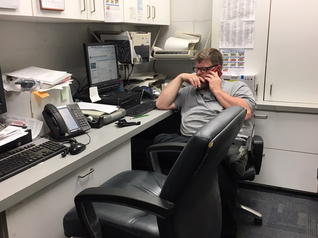  Maintenance worker Fred Napier talks on the phone with the company that helps fix the school’s roof leaks. This is one of many things that maintenance workers have to do to help keep our school in prime condition.