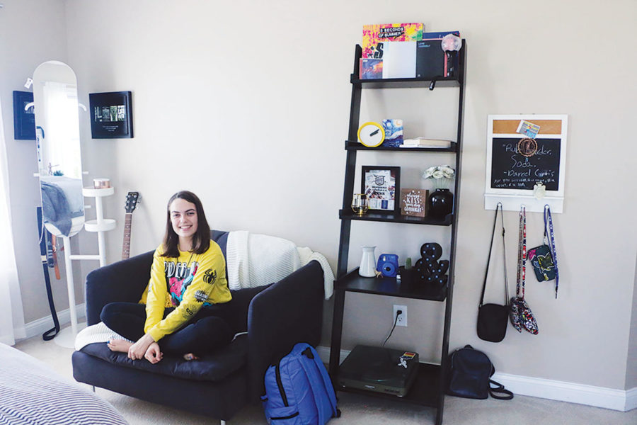 Sophomore Ashley Elmore’s sits on the loveseat in her room. Elmore said she thinks different elements of her room, such as her mirror and loveseat, are interesting pieces that add to the aesthetic of her room.