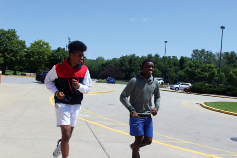 Amit Manchella, cross-country runner and sophomore, and Daniel “Dan” Musapatika, cross-country runner and junior, run together at summer  practice. Manchella said summer helps prepare the team for the season when the school year starts.