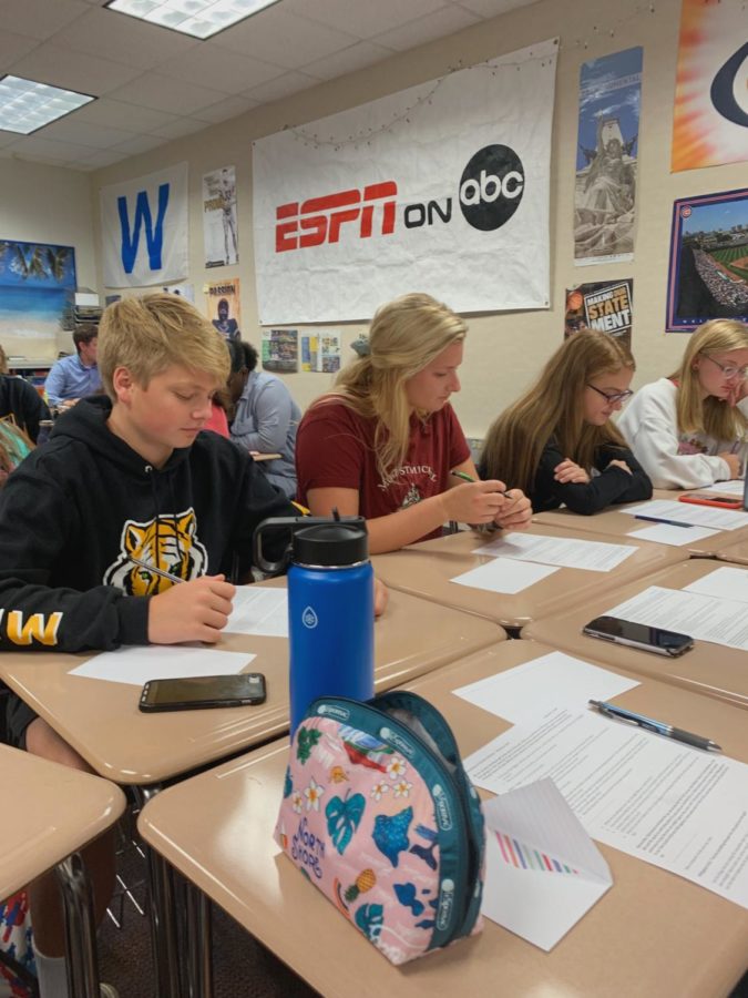 FCA members and siblings Olivia and Ryan Roop read their Bible verses in FCA faculty sponsor Connor Bradley’s room on Tuesday morning. They begin their school day with a connection to God and friends around them. 

