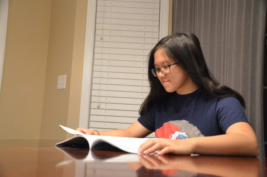 Freshman Jennifer Zhao looks at her program of studies to help her choose her classes for sophomore year. Scheduling will begin Nov. 1, and freshmen will meet with counselors, individually, for scheduling mid-November.