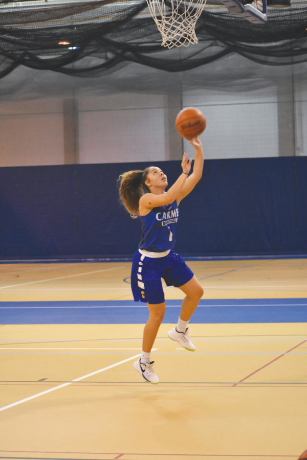 SOFT TOUCH: Senior Kiara Gill shoots a floater during practice. Gill said the team shared a close bond even before tryouts commenced, adding that those bonds will be crucial for a successful season.