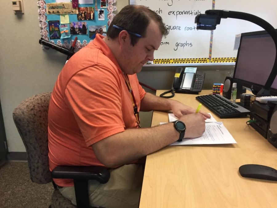 Joseph Broman, sponsor and math teacher, reviews upcoming competitions for Math Club on his computer. Broman said many of the competitions will take place during first semester.