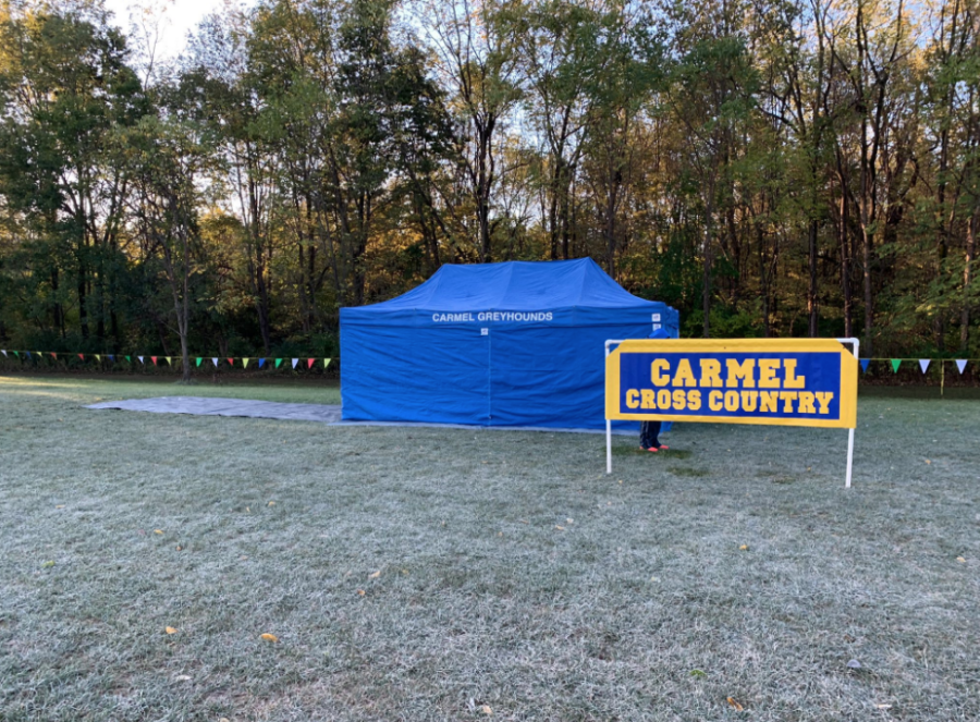 The cross-country banner and tent get set up prior to a meet. Varsity runner and senior Phoebe Bates said, “We are hoping to finish the season strong and win another State championship.” 