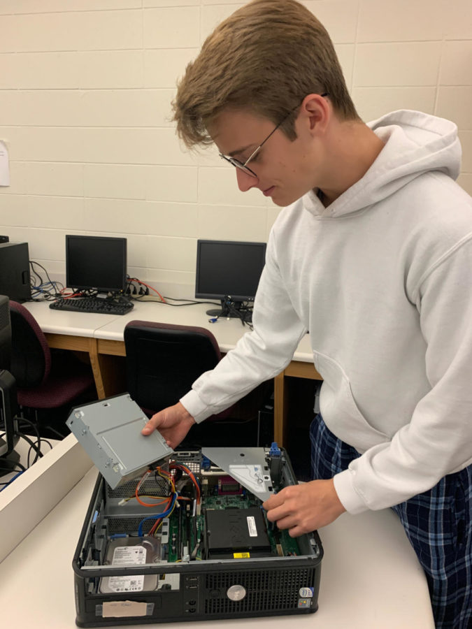 Community Computer Repair Club member Aden Shaw learns the components of the computer. Shaw is required to be familiar with the computer hardware to assist in the refurbishing process.