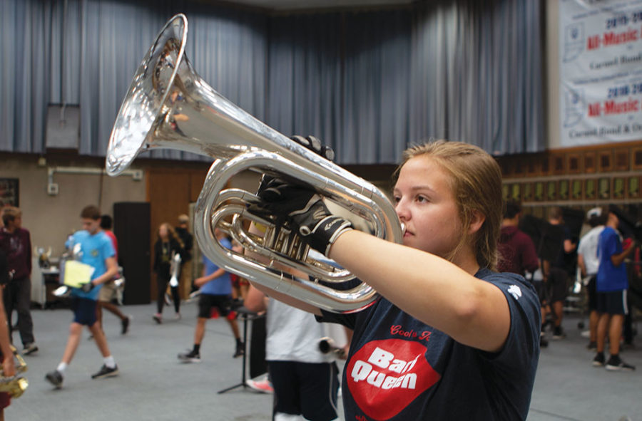 FOR THE BAND:
Senior Katy Carson plays the baritone during marching band rehearsal. She said she was motivated to learn to play the instrument after joining the band.