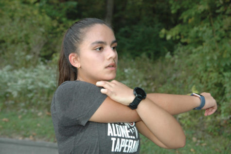 STRETCHING OUT: Ultramarathoner and sophomore Kaitlyn Varghese stretches before her run. Varghese said training for these long distances has helped her with valuable life skills such as patience. She added that it was important to gradually build up mileage to avoid injury and leave room for improvement.
