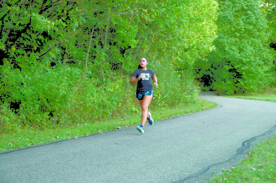 IN TO THE WOODS:
Ultramarathoner and sophomore Kaitlyn Varghese runs in preparation for an ultramarathon. Varghese said that she usually runs ultramarathons one to two times a month. She added that she also runs half-marathons and marathons to help train for these longer distances. 