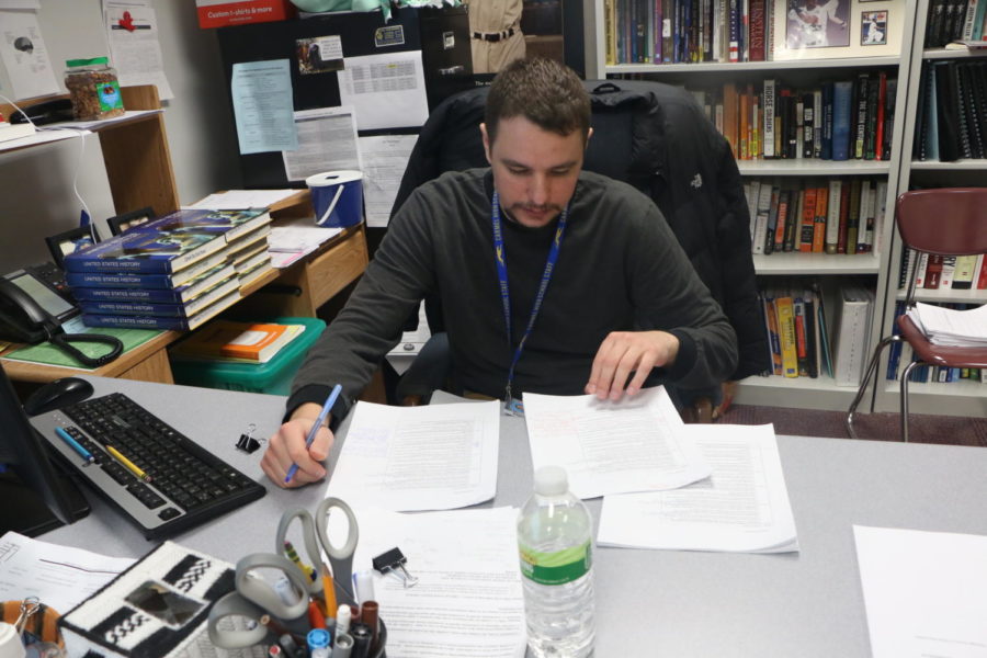 Club sponsor James Ziegler looks over assignments after class. According to Ziegler, the club only has one more meeting left before the end of the year.
