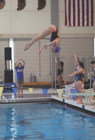 Diver and sophomore Darci Commons flips through the air during practice. Darci said that there are multiple types of dives including back, reverse, and inwards.
