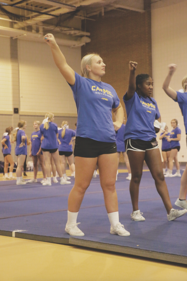 Winter cheerleaders, senior Eve Szydlowski and junior Trinity Griffin, practice their routine. Szydlowski said the time commitment for winter cheerleading is less intense compared to football cheer or ICE. 