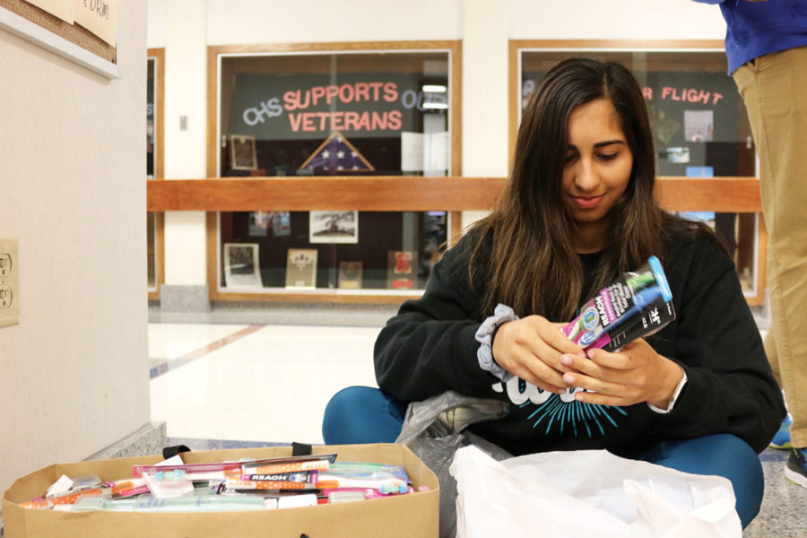 THE CLUB THAT SMILES BACK:
Emily Deldar, founder and president of World Smiles Mission and senior, organizes toothbrushes for World Smiles Club during SRT. Key Club collected unused dental supplies to give to Deldar for World Smiles Mission. 