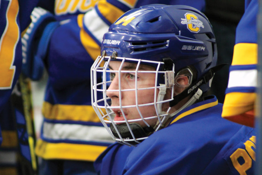 STAREDOWN:
Nick Popowicks, a junior and forward on the Icehounds gold team, watches the game after finishing his shift during the Icehounds 5-2 victory over Zionsville. Popowicks said that although some Friday night games have student spectators, there are very few people that watch weekend games. I don’t believe that not being associated with IHSAA has affected our performance, but it would be nice for hockey to be recognized as an IHSAA sport.