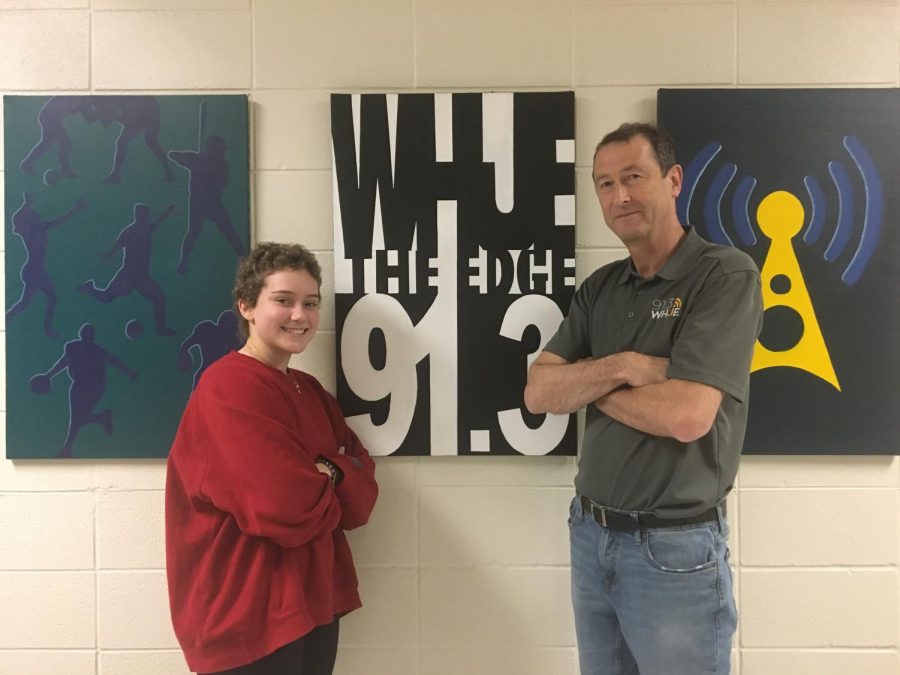 Junior Jess Cooper and radio adviser Dominic James stand by the WHJE sign. Cooper said WHJE will partner with Cabinet to raise money for Riley.
