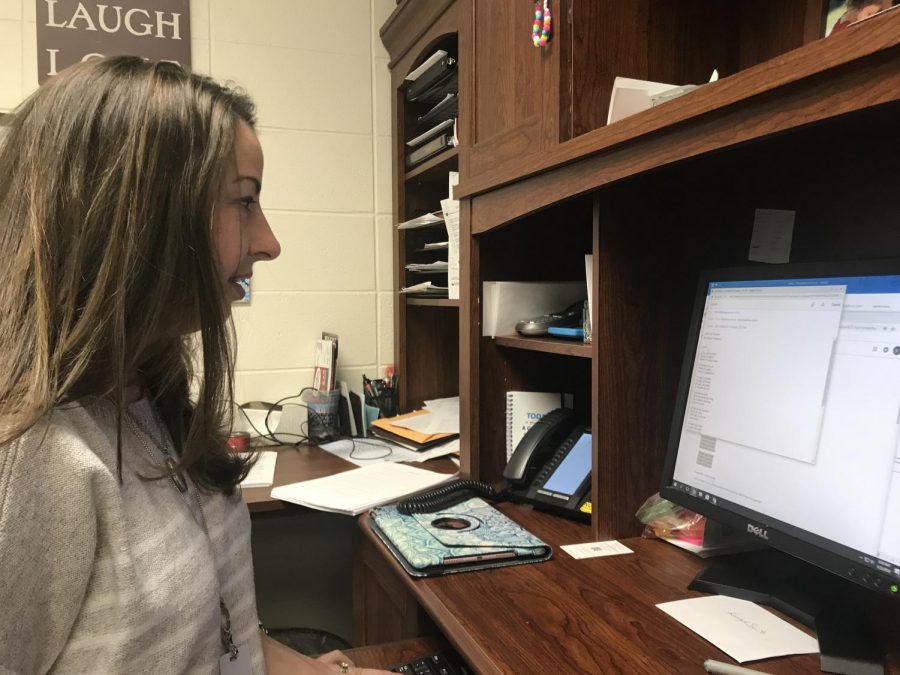 Director of Choirs Katherine Kouns reviews the lyrics to a song in her office on Jan. 17. The song was sung by Accents as part of their competition set.