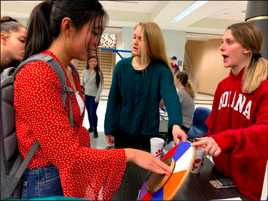 Senior Class vice president Lydia Yong plays a game in the Stats Fair during SRT. Its fun to see the different types of projects people within our school have worked hard on, Yong said.