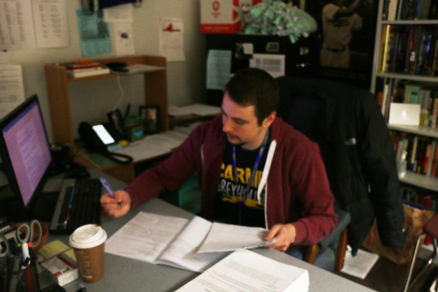 Club sponsor James Ziegler looks over assignments during passing period. According to Ziegler, Indiana-based activist Tim Bagwell will speak with the club during late February.
