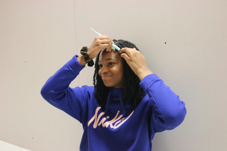 DAILY BRUSH:
Freshman Kiah Jackson applies hair gel using a brush  to lay her edges. Jackson said there is a lot of diversity even within the African-American community, so it can be hard to find products for specific hair types. She said, 
“I personally have a kinkier hair texture, and right now the movement, it’s not that it’s all based on looser hair, but it’s harder to find things with kinkier hair, so that would 
be great.”