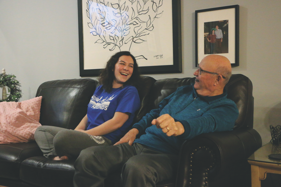 Junior Isabel Jensen and her grandfather watch a music video together for a TikTok. Jensen said she thinks her videos went viral because they involve interacting with other people, which is a heartwarming experience.