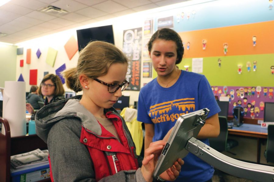 Ella+Joliet%2C+Teen+Library+Council+member+and+sophomore%2C+volunteers+in+the+QUEST+Lab+at+the+CCPL.+The+library+offers+a+variety+of+volunteering+opportunities+for+teenagers.+