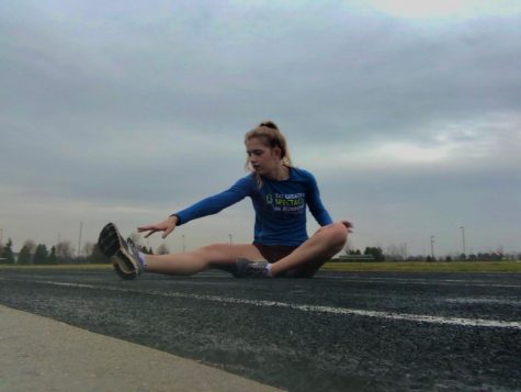 Savannah Hill, track runner and junior, stretches before a run over break. Hill said she would continue to train over the extended school closures although she does not expect the track season to continue this year.