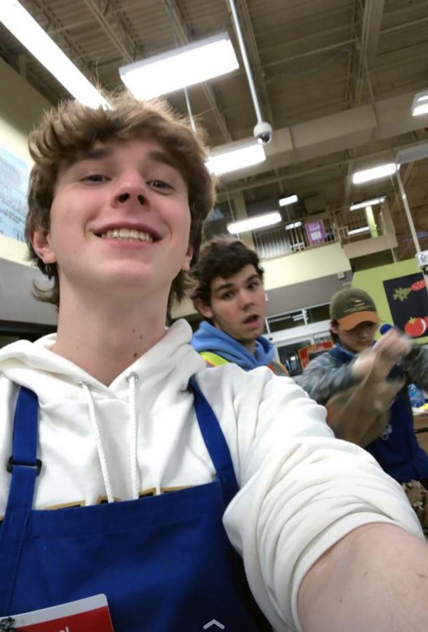 Senior Isaac Beck takes a photo while working at Kroger. Beck said Kroger has been especially busy in recent days. 