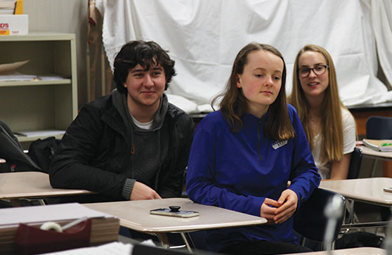 LIVE GREEN: Kai Tomcho (left), Ella Yates (center) and Annie Surrette (right) listen in on a discussion about how youth should stand up for the environment. Stoehr said he lives sustainably at home. 

