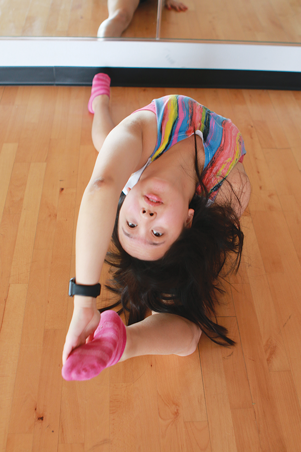 BENDING BACKWARDS:
Senior Hannah Liu stretches before dancing. Liu said she choreographs easier dances for younger students to keep them motivated to learn to dance. 