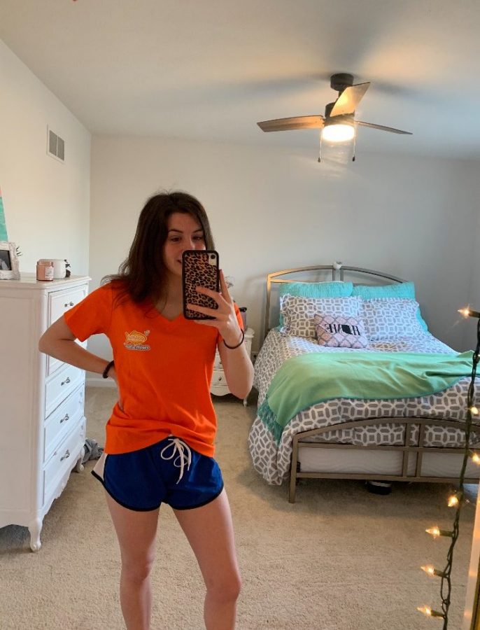Sophomore+Grace+Hutton+poses+in+her+Goldfish+Swim+School+shirt.+Hutton+served+as+a+swim+teacher+at+the+school+until+it+temporarily+closed+following+the+stay-at-home+order+due+to+COVID-19.