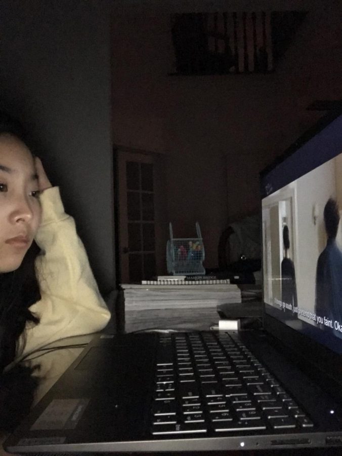 Sophomore Aleen Zhao watches videos on her laptop. She said that by maintaining a routine during this e-learning period, she is able to be more productive and ultimately have more time to do things she wants to do. (Submitted Photo: Aleen Zhao)
