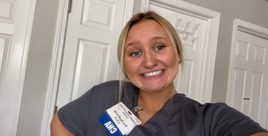 CNA and senior Eve Szydlowski poses in her scrubs. Szydlowski got her CNA certification after taking a course at the J. Everett Light Career Center and currently works at an assisted care home.
