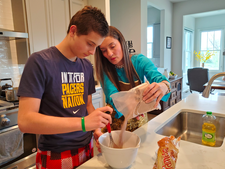 Alejandro Rojas and Ana Perez pour baking mix into the bowl as they make brownies in their house on May 11, 2020. This was Rojas’ first hand at making caramel brownies he saw from Tasty. “After this quarantine, I have realized that knowing how to bake/cook is extremely important,” Rojas said.