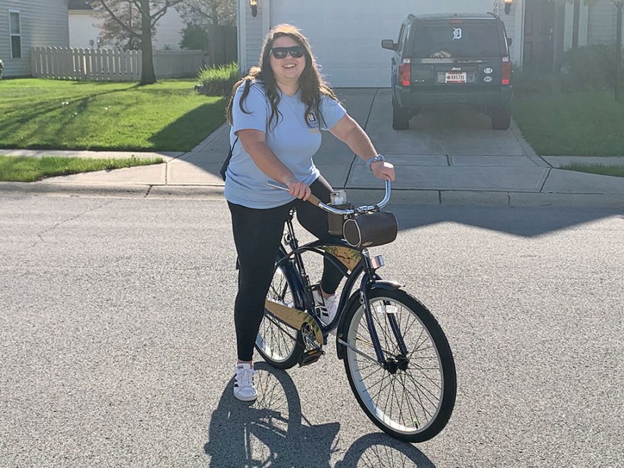 Senior Stephanie Morton stands on her bike before going on a bike ride with her friends. She said riding her bike has been a good way to socially distance with her friends while remaining active.