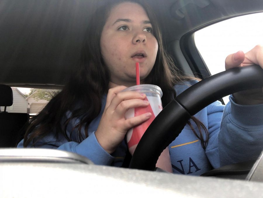 Senior Stephanie Morton de-stresses by driving while sipping on her Smoothie King drink. Morton said driving helps improve her mental health allowing her to get out of the house.