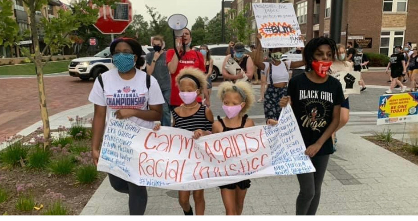 Morgan+Blakey+%28right%29%2C+Black+Student+Alliance+co-founder%2C+co-president+and+senior%2C+holds+a+sign+at+a+protest+in+downtown+Carmel+this+summer.+Blakey+said+the+Black+Student+Alliance+has+been+attending+more+protests.%0A
