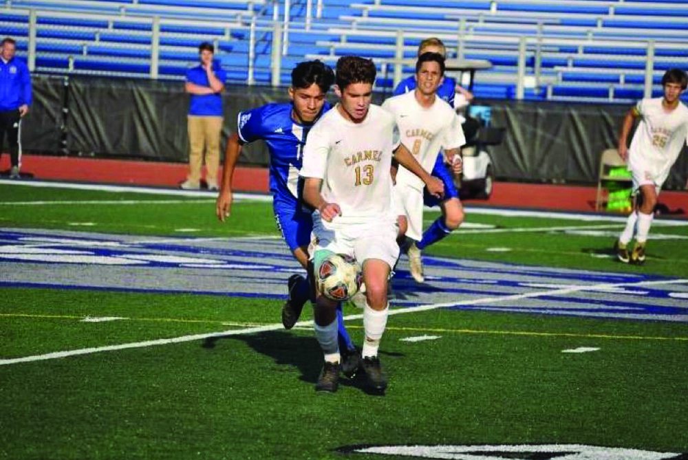 Senior Jackson Carl receives a ball during a soccer game in the 2019 season.Carl said he has one goal on his mind despite the ongoing pandemic: winning the State Championship.